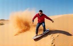 Person sandboarding down dune